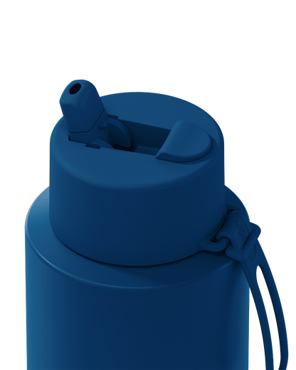 Close-up of a dark blue insulated water bottle showing the flip-top lid and carrying loop against a white background.