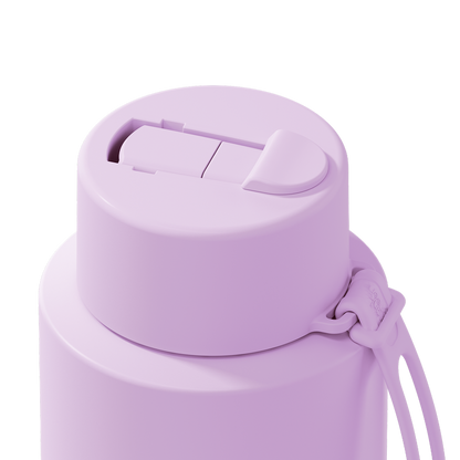 Close-up of a matte light purple insulated water bottle lid with a flip-top straw opening and a matching carrying strap on a white background.
